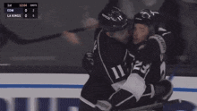 two hockey players are hugging each other during a game between the la kings and edm