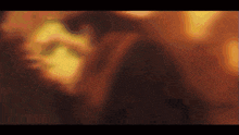 a close up of a person 's face with a blurry background of lights