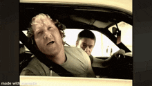 a man sitting in a car with his eyes closed is made with memematic