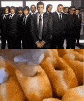 a group of men in suits and ties are standing in a line