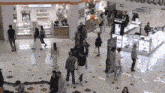 a large group of people are walking through a shopping mall with a sign that says we fiscal