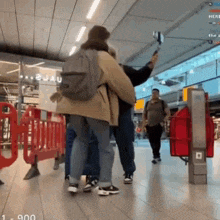 a man taking a picture of a woman with a selfie stick
