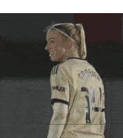 a female soccer player wearing a number 24 jersey