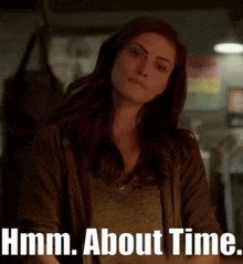 a woman with a serious look on her face is next to the words hmm about time