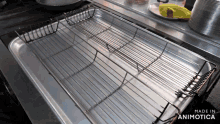 a stainless steel tray on a stove that says made in animotica on the bottom