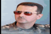 a man in a military uniform is wearing sunglasses