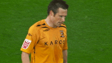 a soccer player wearing a yellow shirt with the word kro on it