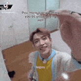 a young man taking a selfie with the caption " pov hongjoong patting you bc you 're doing well " on top