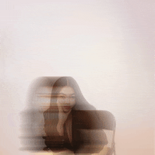 a blurry picture of a woman with long hair