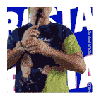 a man is holding a microphone and wearing a shirt that says rasta