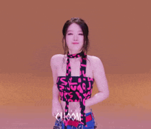 a woman wearing a choker and a halter top with the word choom on it