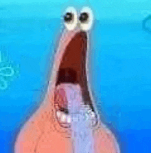 a close up of patrick star from spongebob squarepants with his mouth open and big eyes .