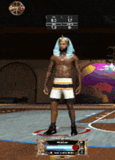 a man in a pharaoh costume is standing on a basketball court in front of a scoreboard that says anteup
