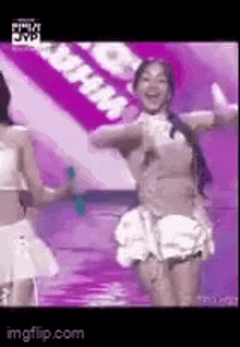 a group of women are dancing on a stage .