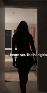 a silhouette of a woman standing in a doorway with the words " i heard you like bad girls "