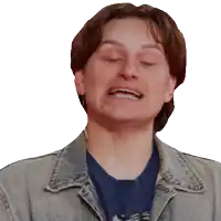 a man wearing a denim jacket and a blue shirt is making a funny face with his eyes closed