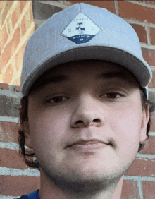 a man wearing a gray hat with a patch on it that says ' tampa '
