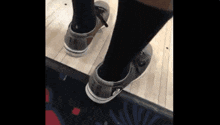 a person wearing a pair of bowling shoes with lr on them