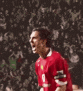 a soccer player wearing a red shirt that says ' united ' on it