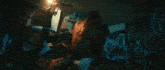 a man is laying on the floor surrounded by posters including one that says ' a '