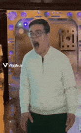 a man wearing glasses and a white sweater is standing in front of a door with a viggle.ai sticker on it