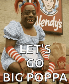 a wendy 's sign is behind a woman in a costume
