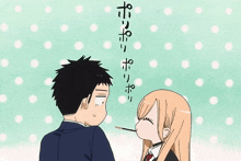 a man and a woman are standing next to each other and the woman is eating a poke stick