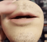 a close up of a man 's mouth with a beard and teeth