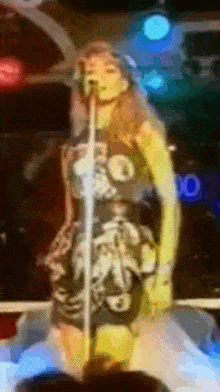 a woman singing into a microphone with the letter o in the corner