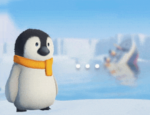 a penguin wearing an orange scarf is standing on a snowy surface