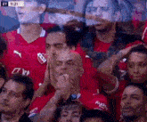a group of people are sitting in a stadium watching a soccer match .