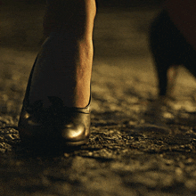 a close up of a woman 's foot wearing black high heels