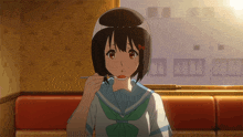 a girl with a bun on her head is eating something with a spoon