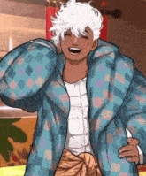 a man with white hair is wearing a blue and pink plaid jacket and laughing .