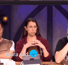 a group of people are sitting at a table and the word laura is on the bottom
