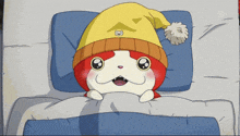 a cat wearing a yellow hat is laying in a bed