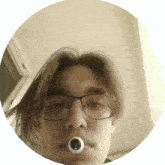 a man wearing glasses and a ring around his mouth