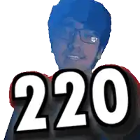 a man wearing glasses is smiling and holding up the number 220