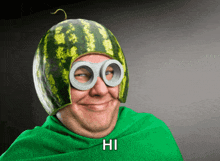 a man wearing a watermelon hat and goggles with the word hi below him