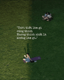 a woman sits on a yoga mat in the grass next to a man