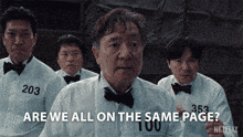 a group of men standing next to each other with one saying are we all on the same page netflix