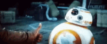 bb-8 is giving a thumbs up to a person .