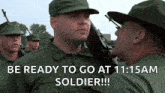 a group of soldiers are standing in a line and one of them is holding a gun and says be ready to go