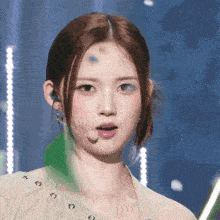 a close up of a woman 's face with a microphone in her ear