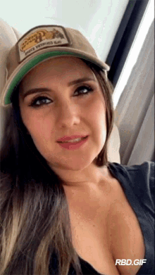a woman wearing a hat that says ' rbd.gif ' on the bottom