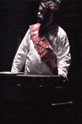 a man wearing a crown and a keep calm sash