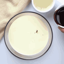 a bowl of sauce next to a bowl of syrup