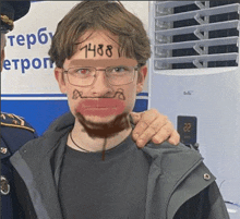 a young man with glasses and a beard has 1488 written on his face