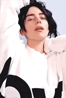 a close up of a person wearing a white shirt with a black and white graphic on it .