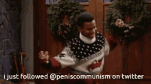 a man in a sweater is dancing in front of a door and says i just followed peniscommunism on twitter